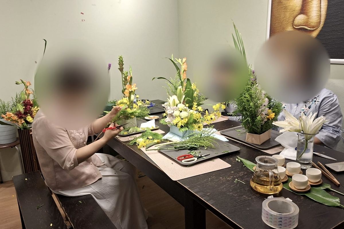 插花课：学员正在修剪花材